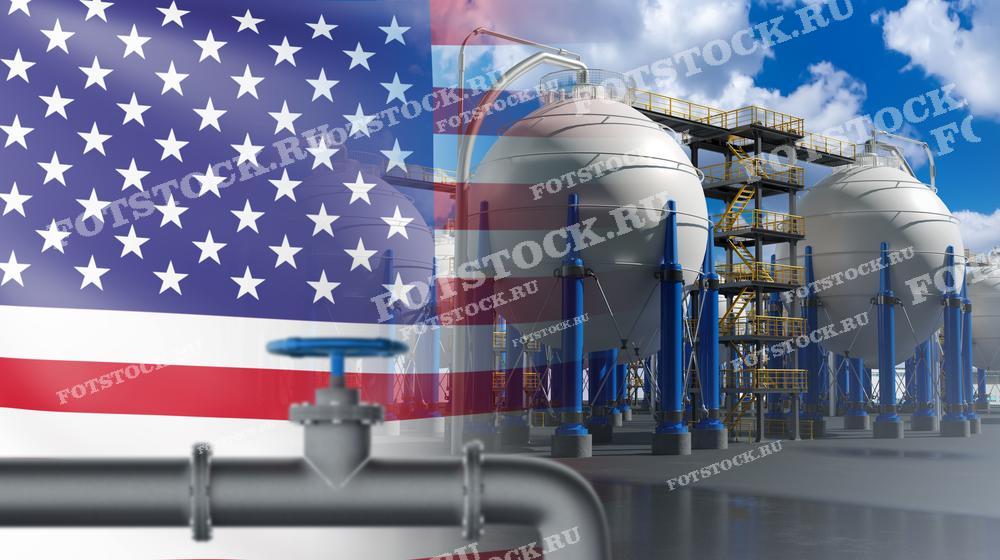 Фотография изображает газовые хранилища и трубопровод на фоне флага США. Этот снимок подчеркивает важность газовой промышленности и инфраструктуры в энергетической системе Соединенных Штатов.